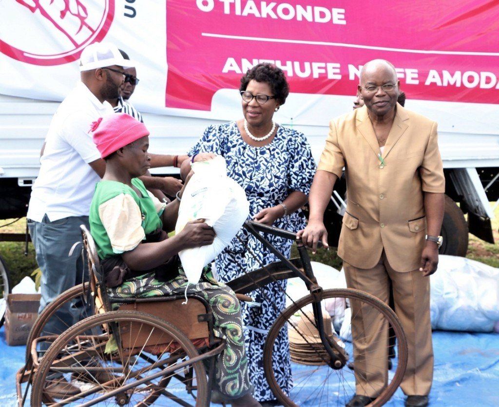 Dr. Jane Ansah Foundation distributing supplies to a beneficiary in a wheelchair